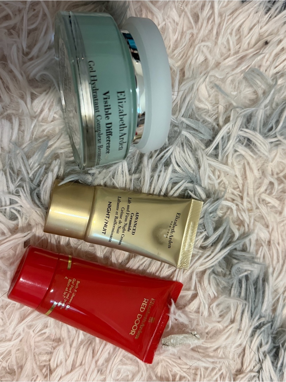 Elizabeth Arden moisturizer trio with light green jar and gold & red tubes